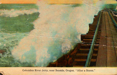 A wave breaks over South Jetty in this colorized picture postcard image from the 1910s. This railroad line is the one used to rescue the crew of the shipwrecked schooner "Admiral" after a wave wedged it into the unfinished jetty.