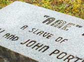 The gravestone of Ame, who despite having died 10 years after the Civil War, was still considered a slave.
