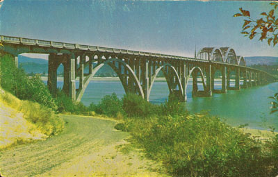 Many people considered this the best-looking of McCullough's Oregon Coast bridges, which, as you likely know, is saying something. It's gone now. This was the bridge across Alsea Bay at Waldport, which crumbled due to the use of salty beach sand in mixing the mortar of which it was built. Many people considered this the best-looking of McCullough's Oregon Coast bridges, which, as you likely know, is saying something. It's gone now. This was the bridge across Alsea Bay at Waldport, which crumbled due to the use of salty beach sand in mixing the mortar of which it was built.